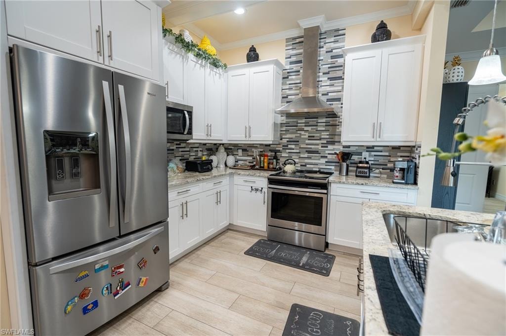 Kitchen featuring white shaker-style cabinetry, stainless steel appliances, granite countertops, and a mosaic tile backsplash