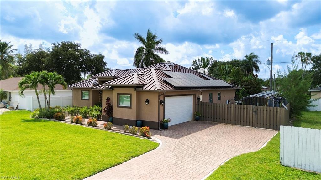 Stucco exterior with a metal roof and solar panels