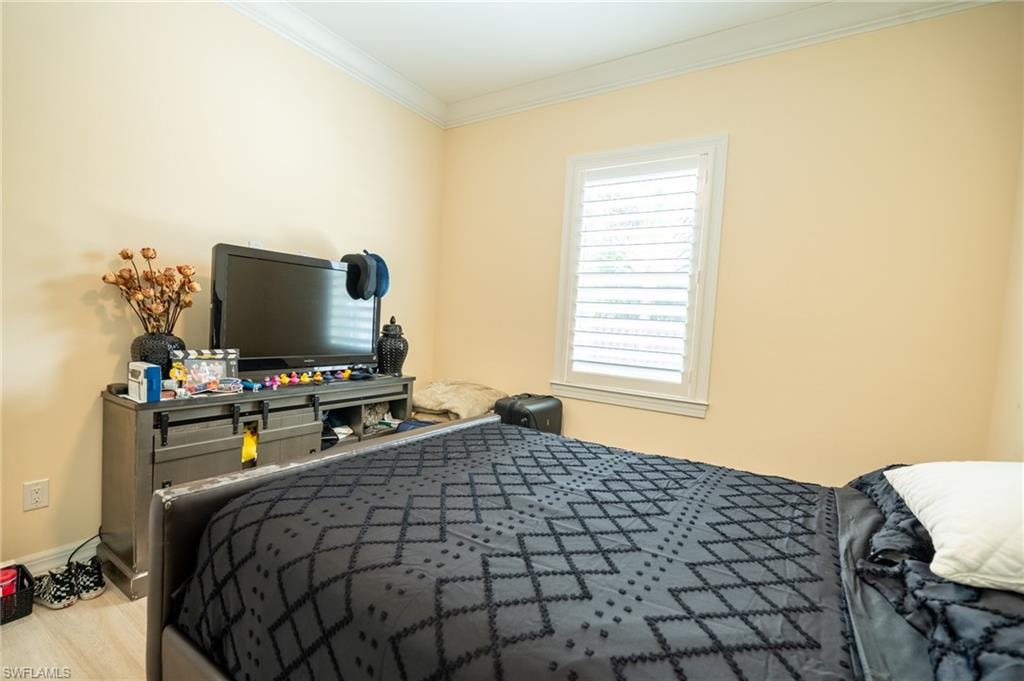 Neutral-toned walls complement crown molding and wood-finish flooring