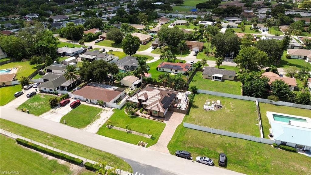 Expansive residential lot with mature landscaping and a partial perimeter fence