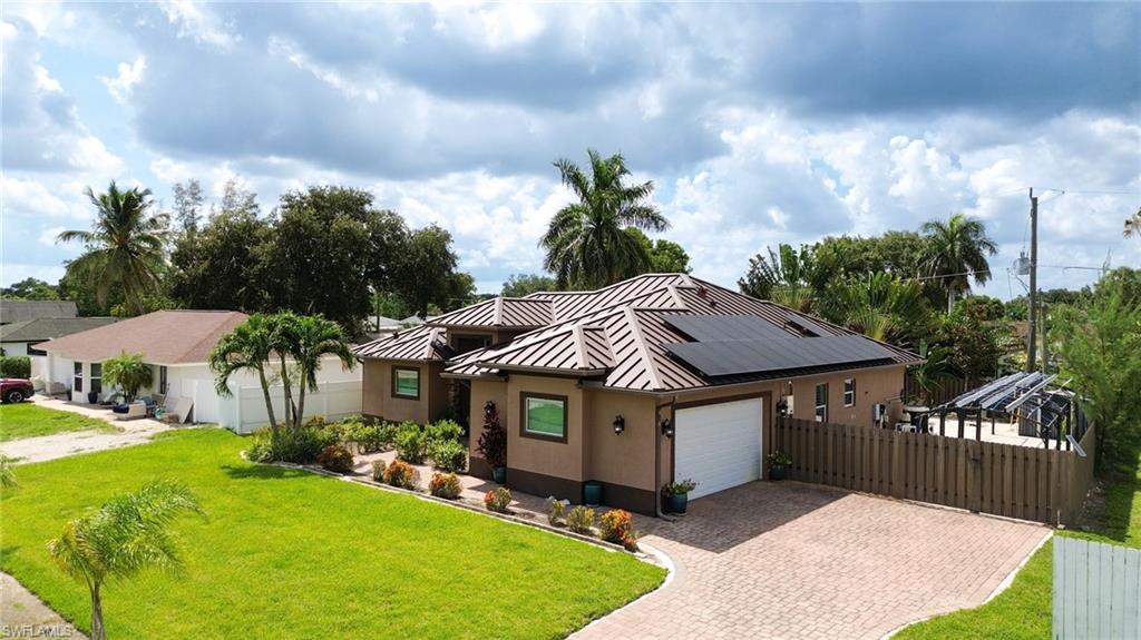 Stucco exterior with a metal roof and solar panel installation