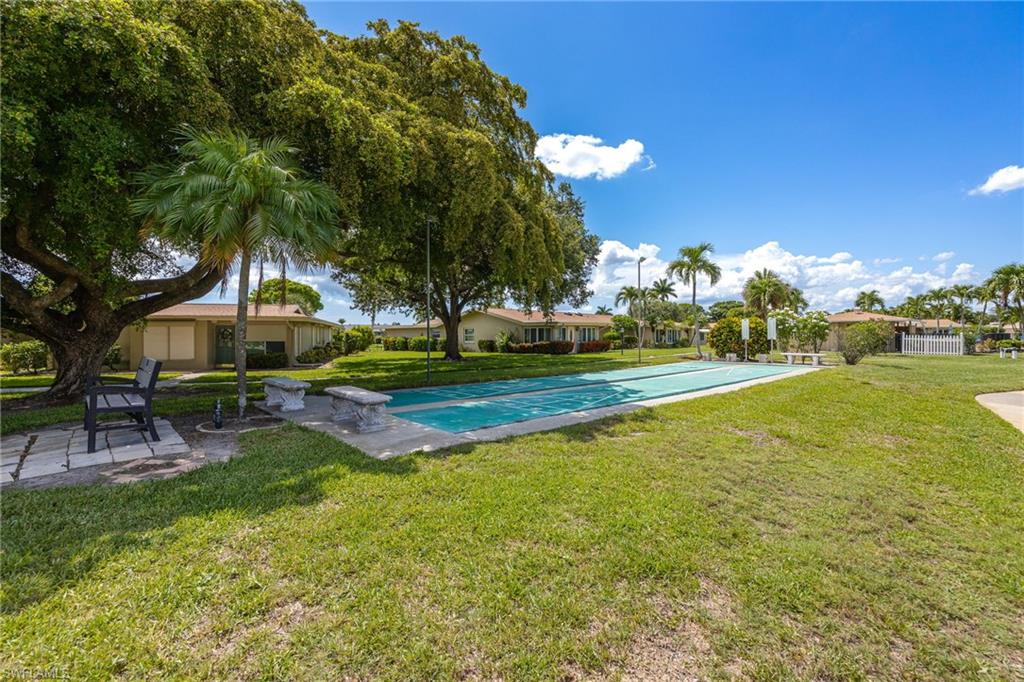Outdoor shuffleboard court with surrounding green space