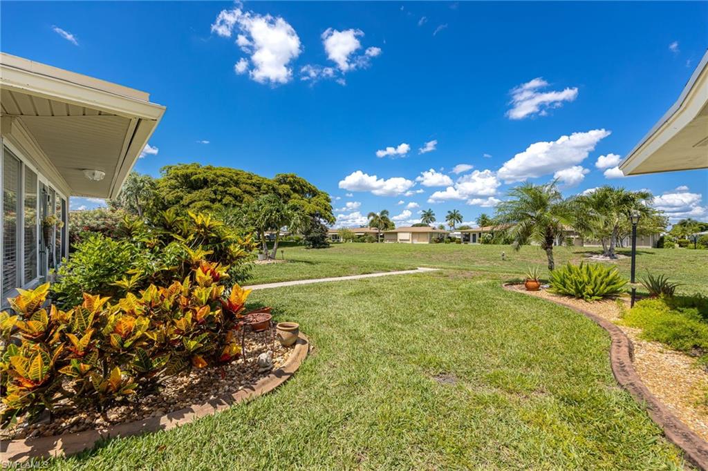 Expansive green lawn featuring mature trees and established landscaping
