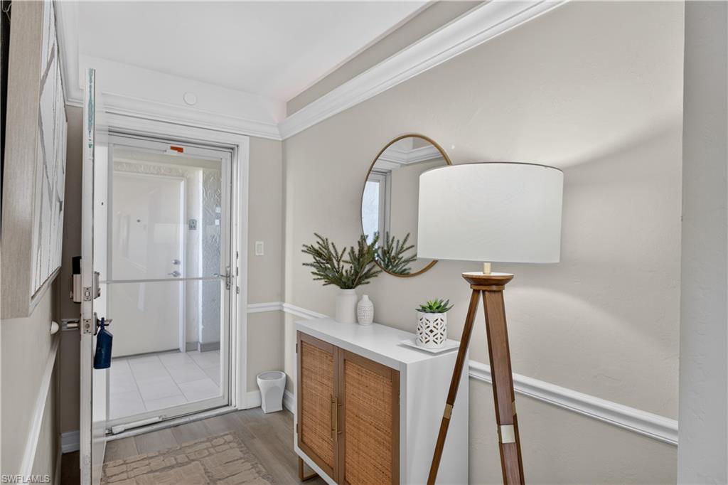 Open Foyer with crown molding with ceiling lighting.