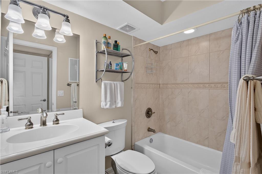Guest bathroom  with custom tile and tub/shower combination.