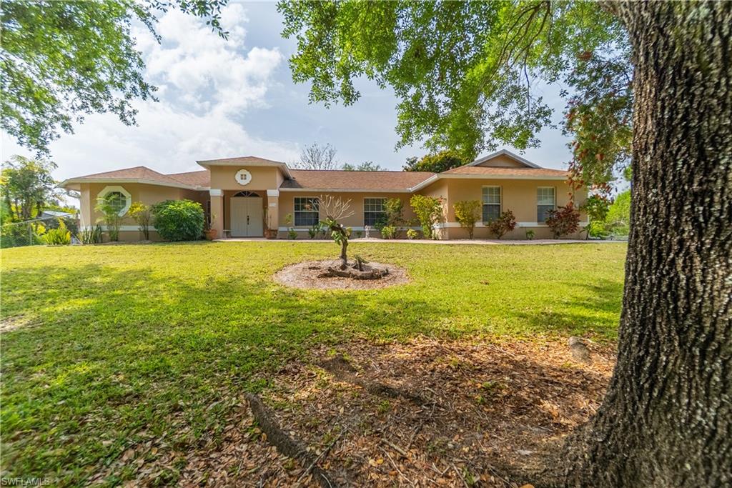 Single story home featuring a front lawn and stucco siding