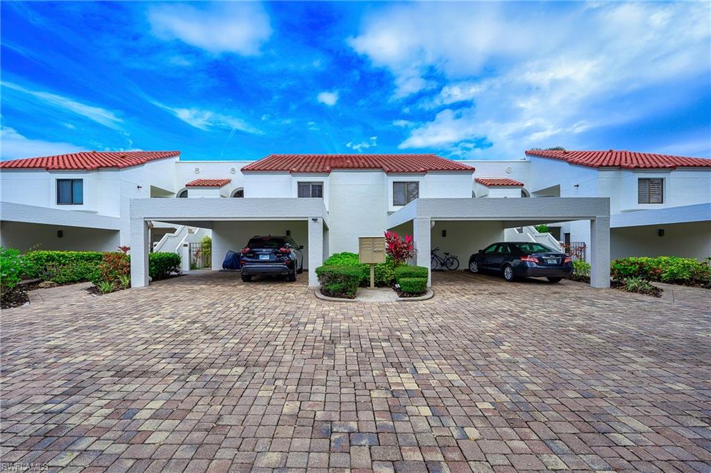Mediterranean / spanish-style home with a carport