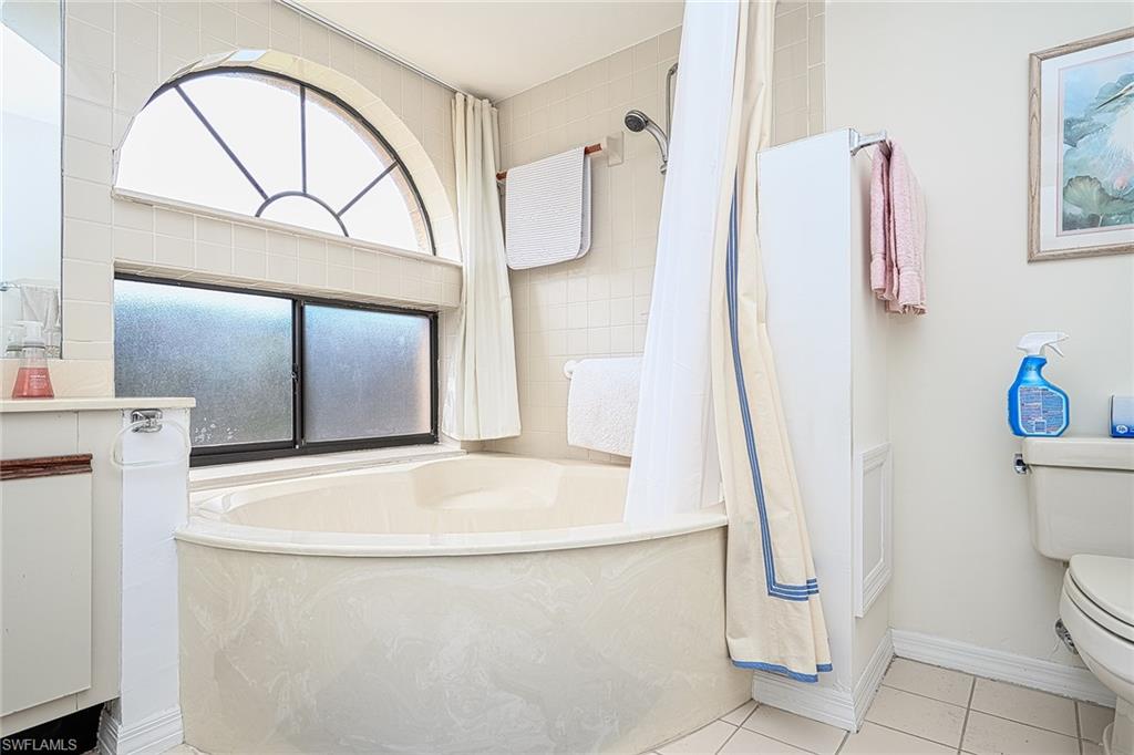 Full bathroom with vanity, toilet, separate shower and tub, and tile patterned floors