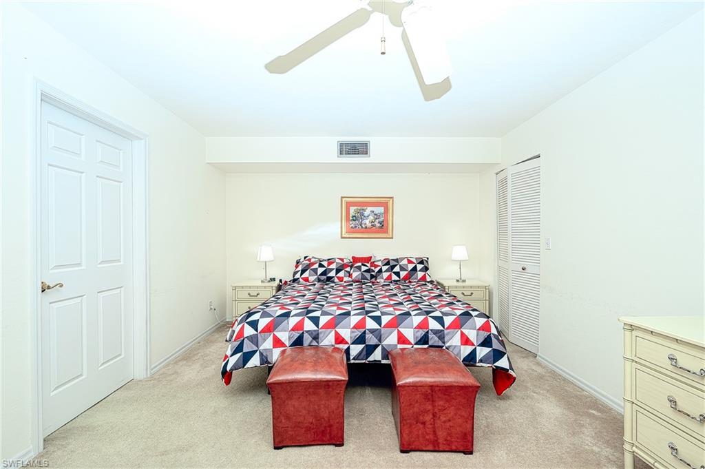 Carpeted bedroom with ceiling fan