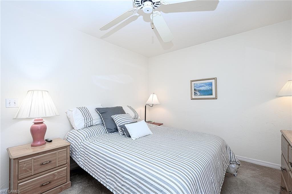 Carpeted bedroom with ceiling fan
