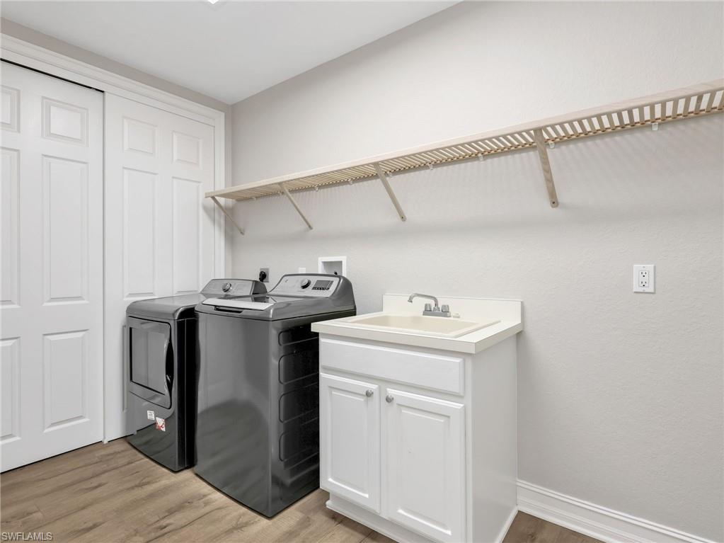 Large Laundry room with hanging and shelf space