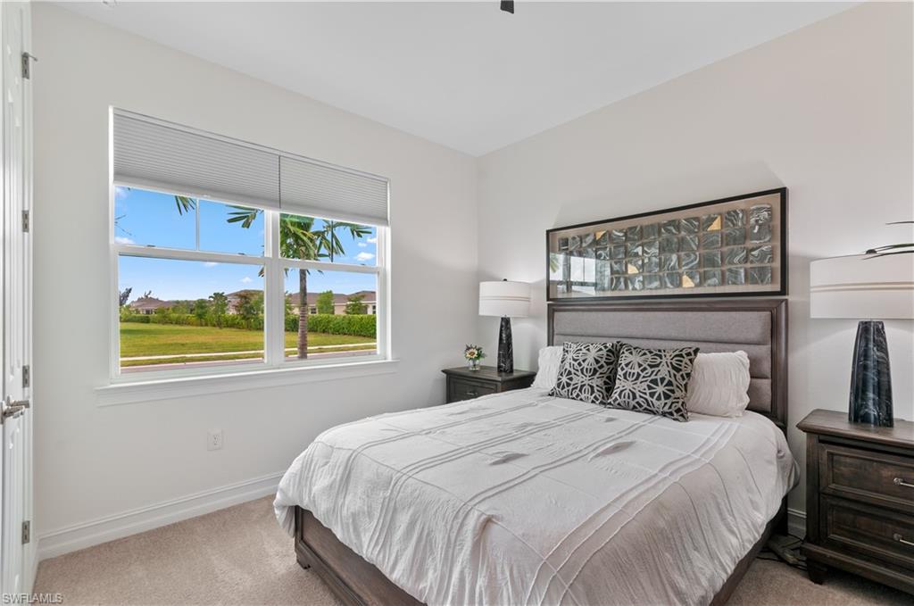 Bright interior space with a large window featuring horizontal blinds