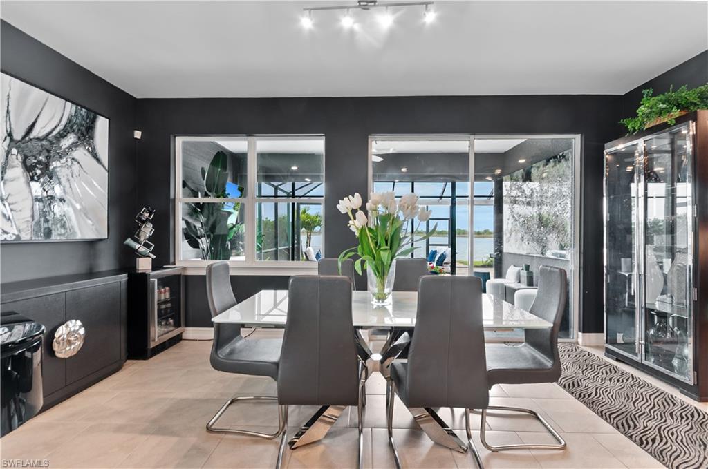 Dining area featuring light tile flooring and dark accent walls