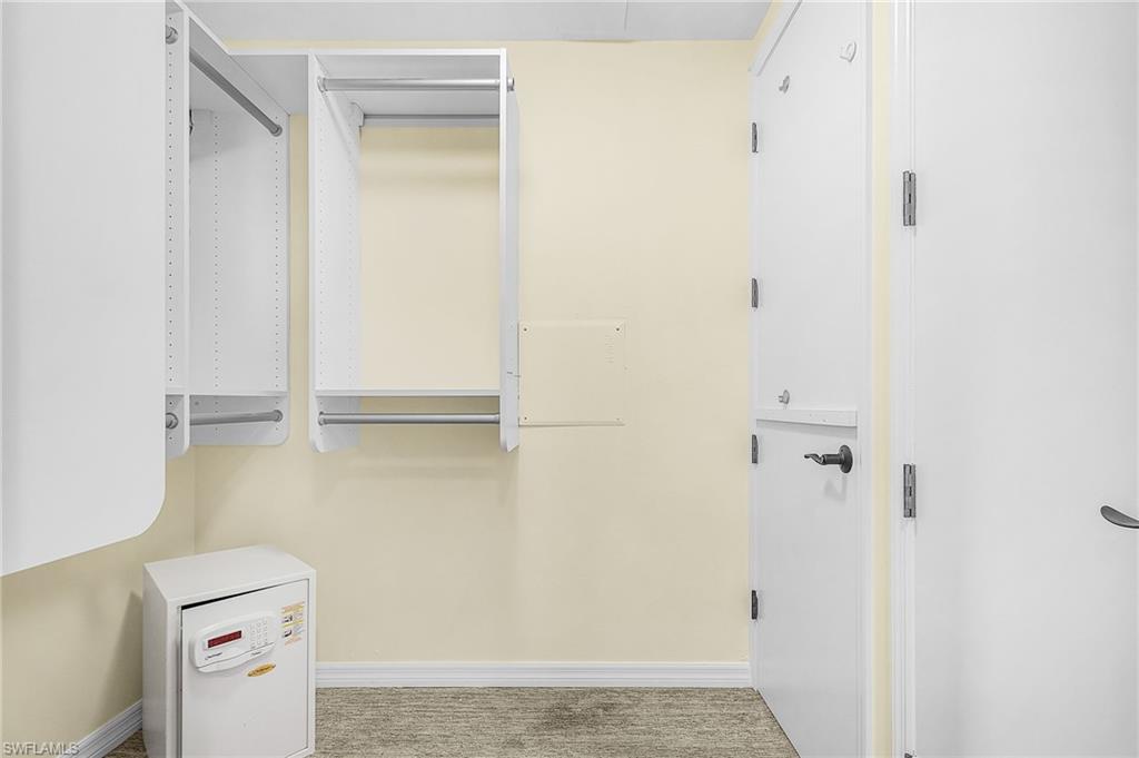 White custom closet organization system with multiple hanging rods