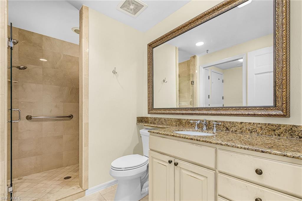 Bathroom featuring a walk-in shower with tile surround and glass enclosure