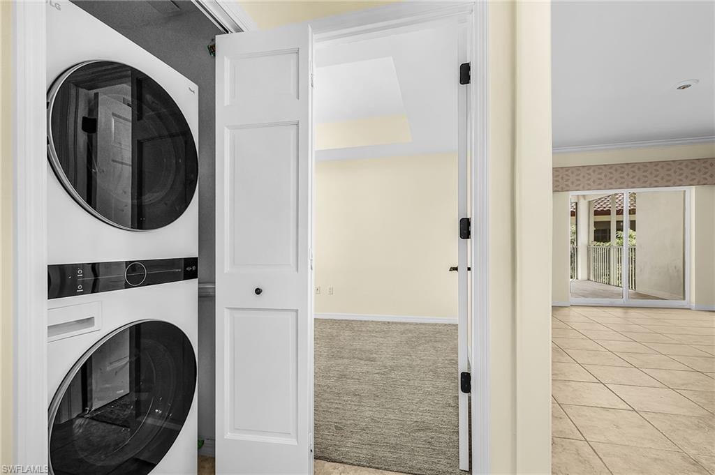 Laundry closet featuring a stacked white washer and dryer unit