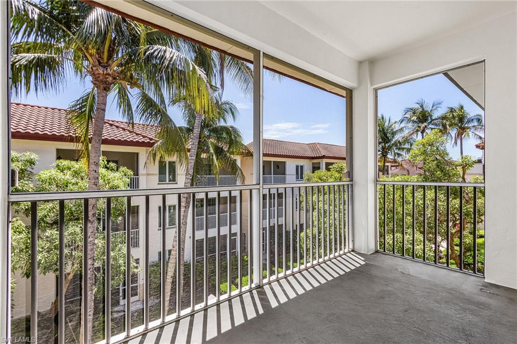 Screened balcony featuring a concrete floor and black metal railings