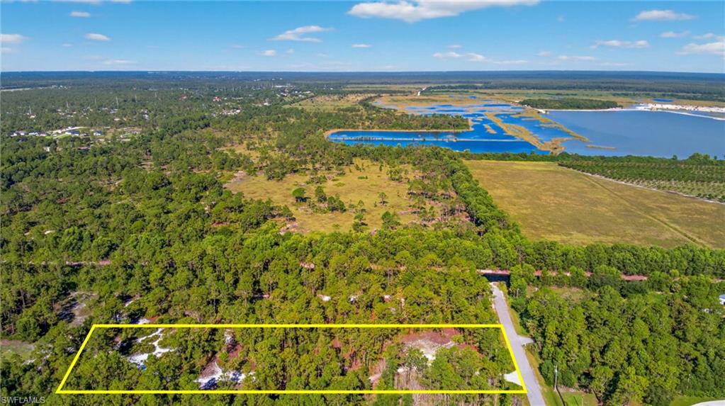 View of rural area with property boundaries highlighted, large plots for crops, and a large body of water