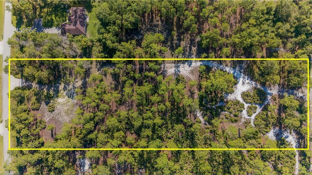 Aerial view of property and surrounding area with property parcel outlined