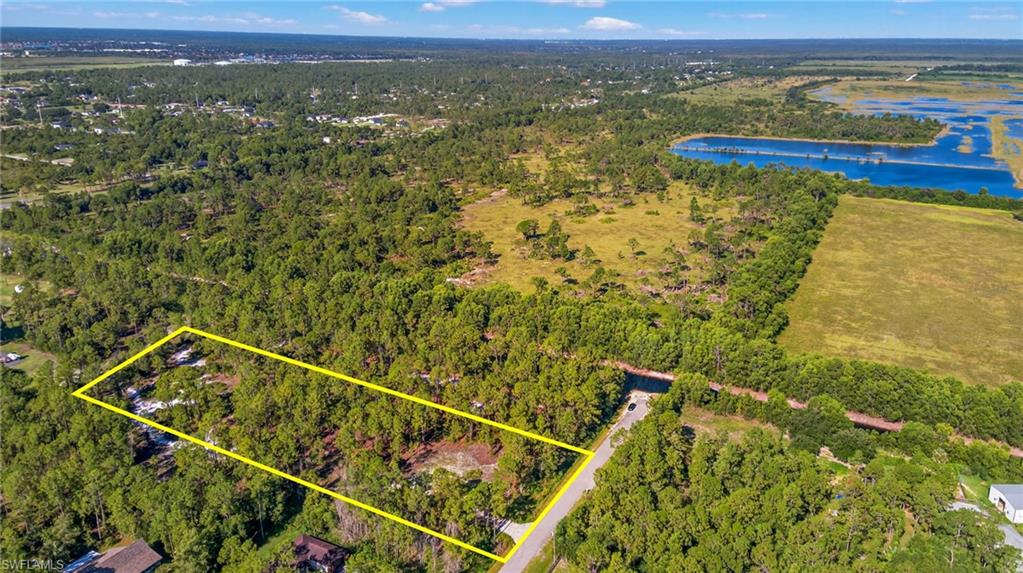 Aerial view of property's location with property boundaries highlighted and a large body of water