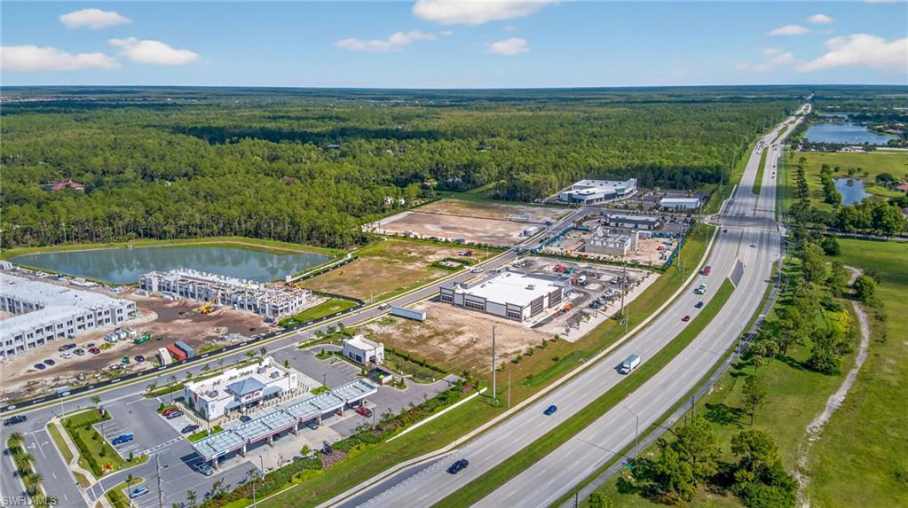 Drone / aerial view of a heavily wooded area and a large body of water