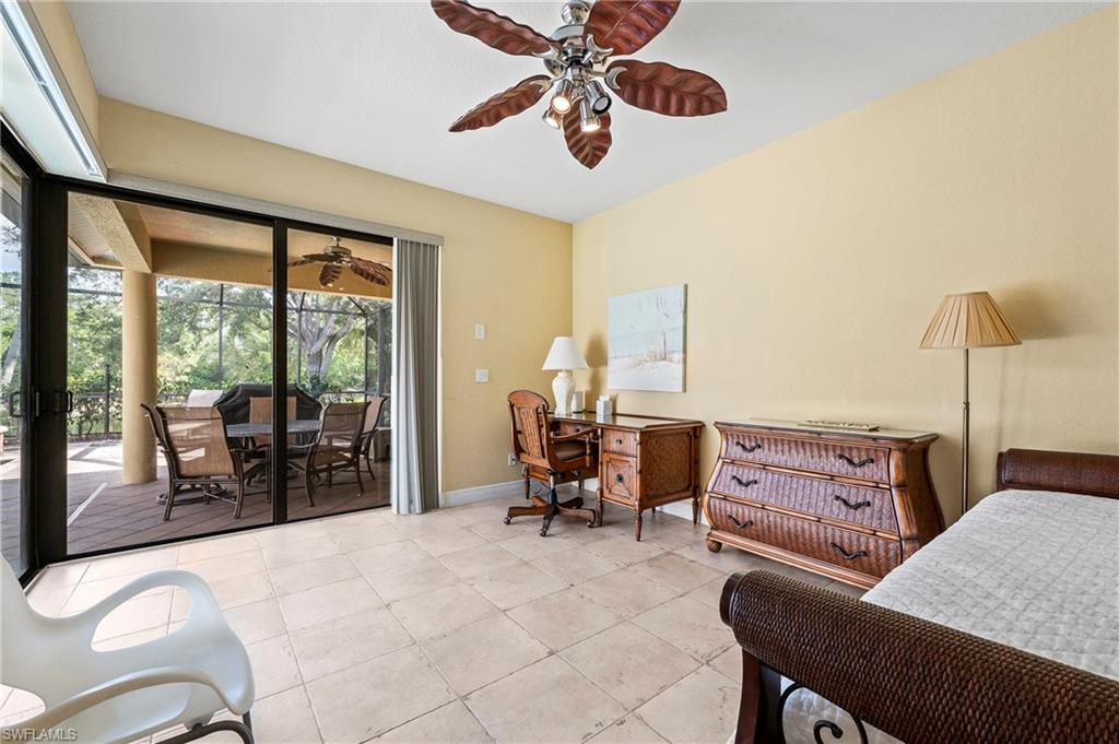 Bedroom with access to exterior, light tile patterned floors, baseboards, and a ceiling fan