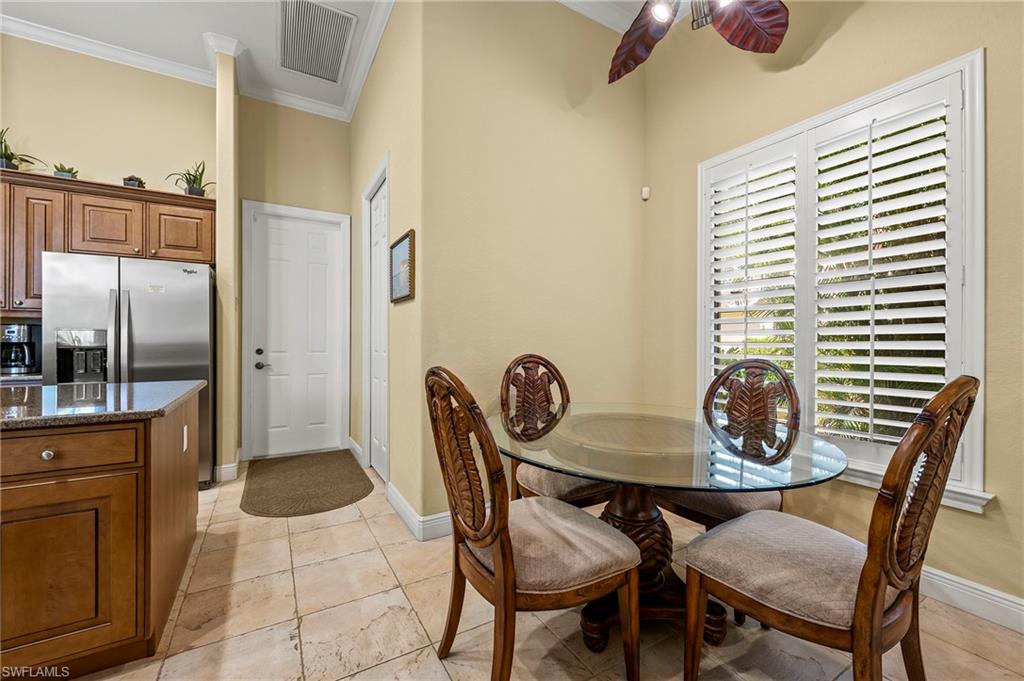Dining area featuring crown molding, ceiling fan, and baseboards