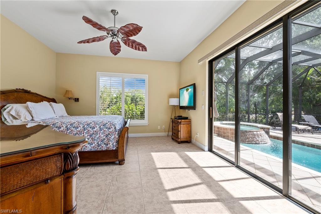 Bedroom with access to outside, light tile patterned flooring, baseboards, and a ceiling fan