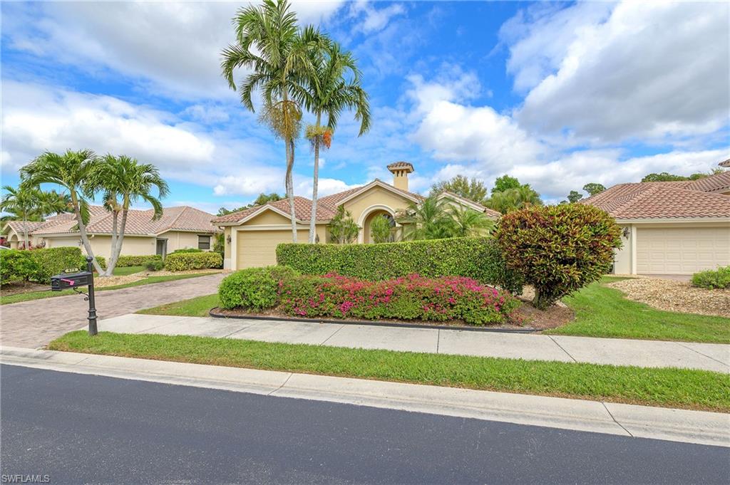 View of front of property featuring stucco siding, decorative driveway, and an attached garage