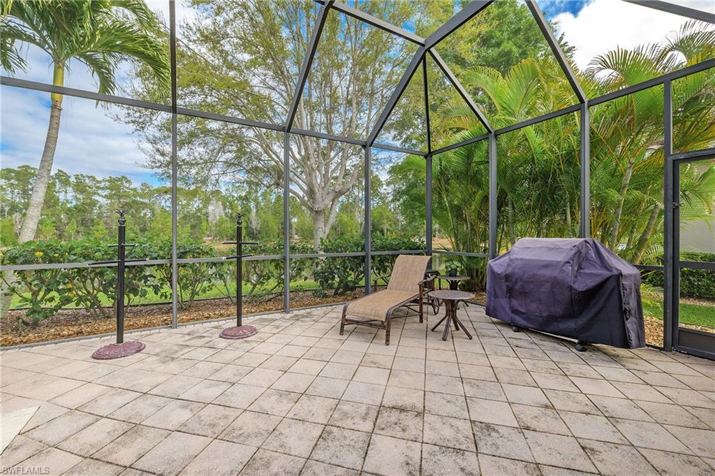 View of patio with area for grilling and a lanai