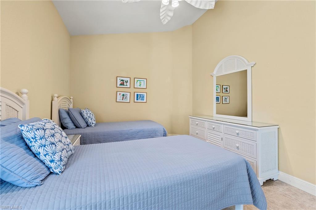 Bedroom with light tile patterned flooring and baseboards