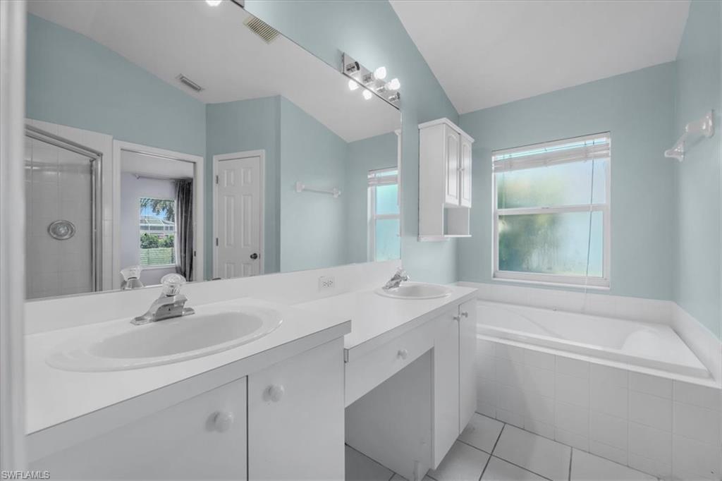 Double vanity with white cabinetry and integrated sinks