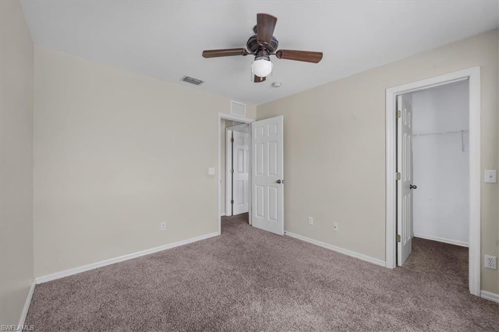 Neutral tone walls with brown carpet flooring