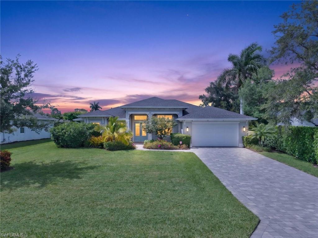 Single-story residence featuring a paver driveway, an attached two-car garage, and a covered entry