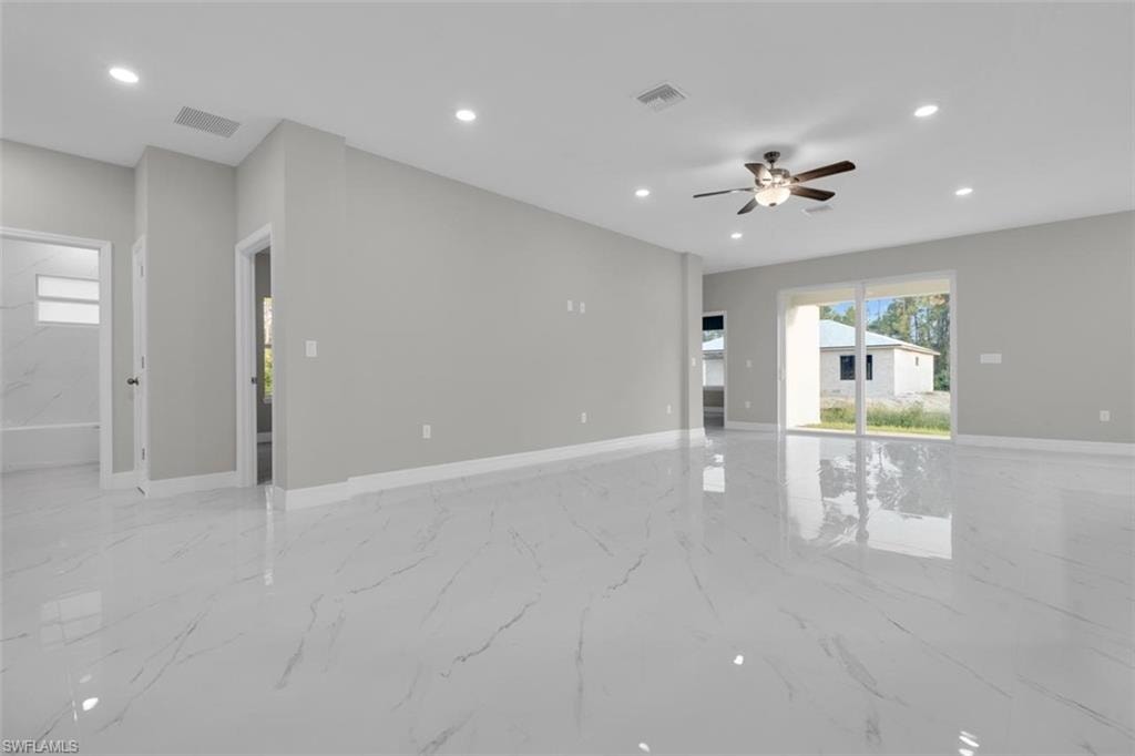 Spacious living area featuring polished white tile flooring, recessed lighting, a ceiling fan with integrated light fixture, light gray wall paint, and white baseboards