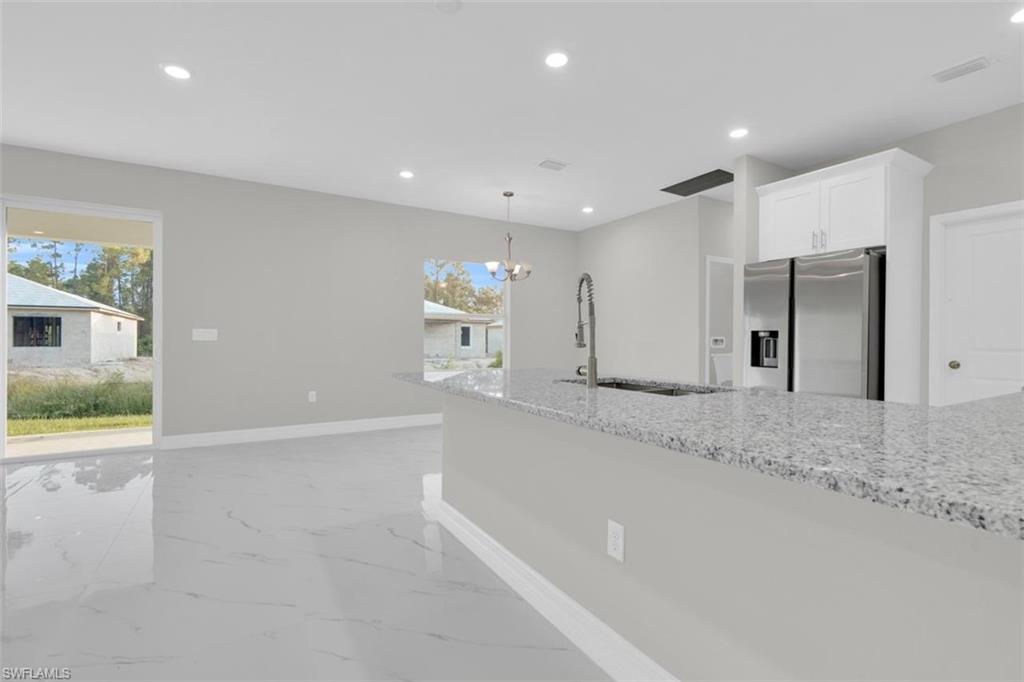 Kitchen island with a granite countertop and an undermount sink