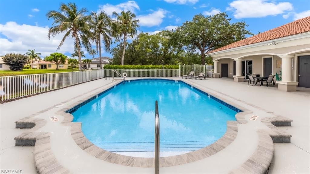 Rectangular swimming pool with integrated steps, surrounded by a paved deck