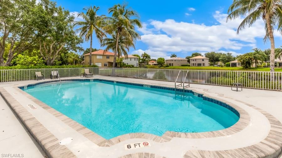 Resort-style outdoor swimming pool with a tile-trimmed edge and integrated steps