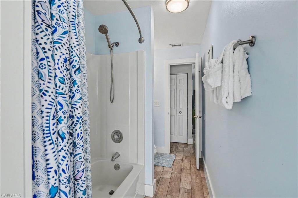 Hallway bathroom near two bedrooms.
