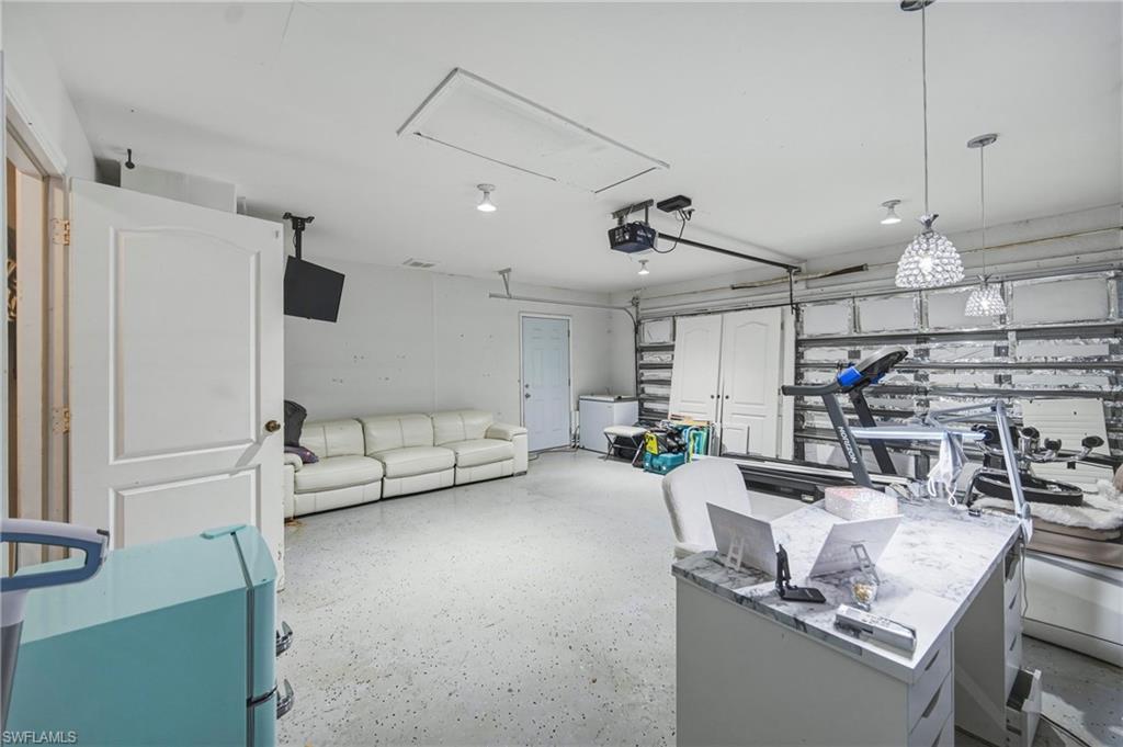Spacious multi-purpose room with textured flooring and recessed lighting