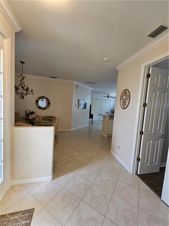 Hall featuring light tile patterned floors and crown molding