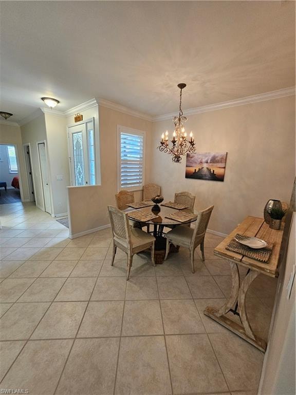 Dining room with light tile patterned floors, crown molding, and suspended lighting