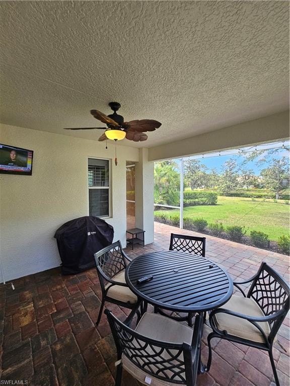 View of patio / terrace with area for grilling, a ceiling fan, and outdoor dining area