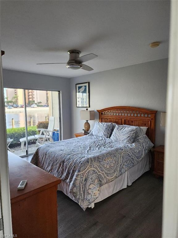 Sleeping area with wood-finish flooring and a ceiling fan