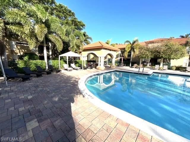 View of pool featuring a gazebo and a patio area