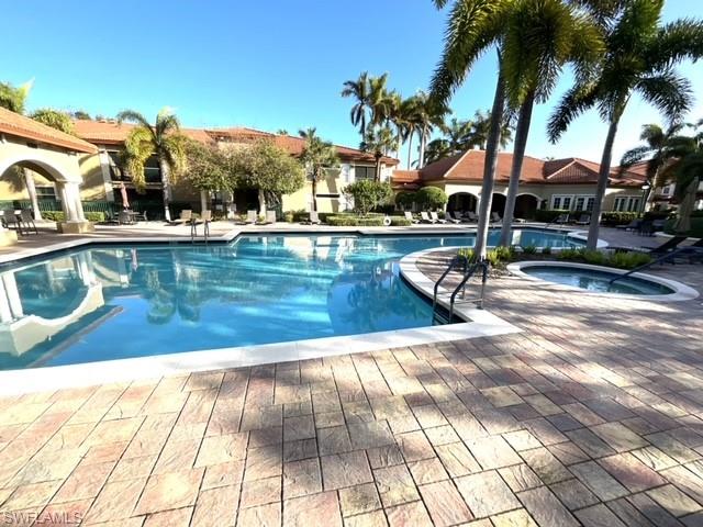 View of pool featuring a patio and a community hot tub
