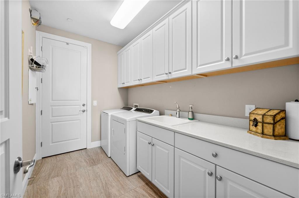 Laundry area featuring cabinet space and washer and clothes dryer