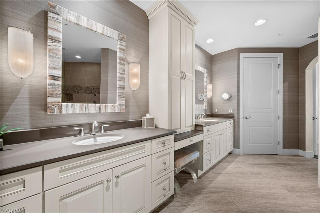 Full bath with vanity and baseboards