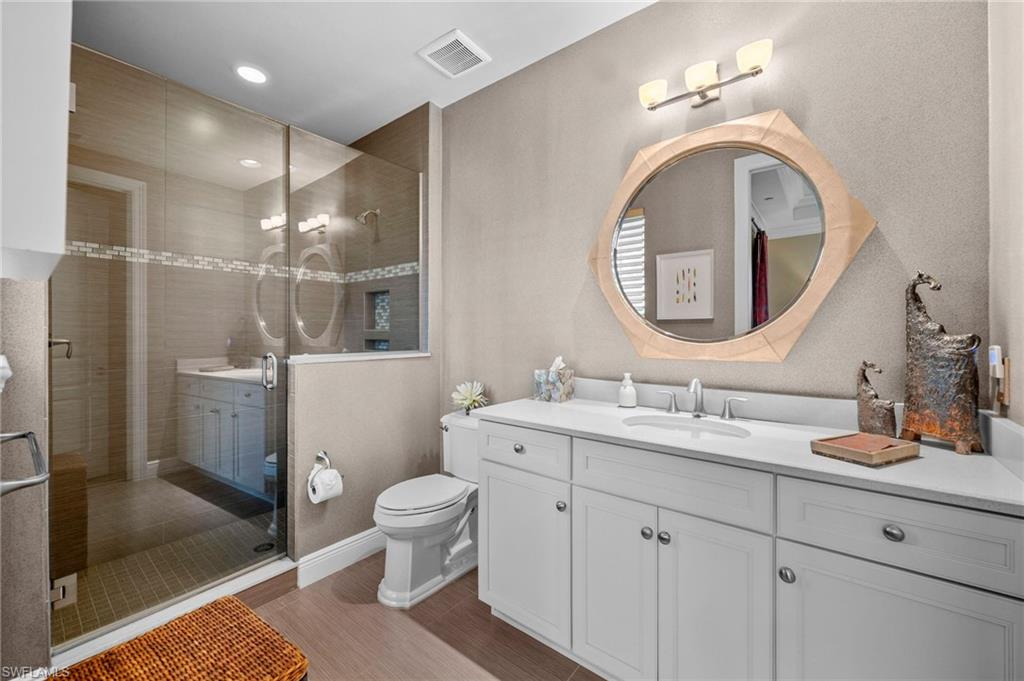 Bathroom featuring vanity, a shower stall, and recessed lighting