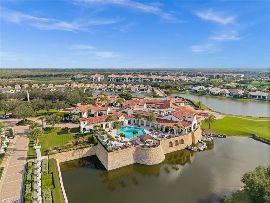 Aerial perspective of suburban area featuring a large body of water and a golf course